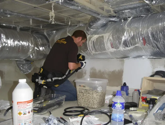 Medfield Air Duct Cleaning specialist performing professional mold removal from air ducts in Medfield