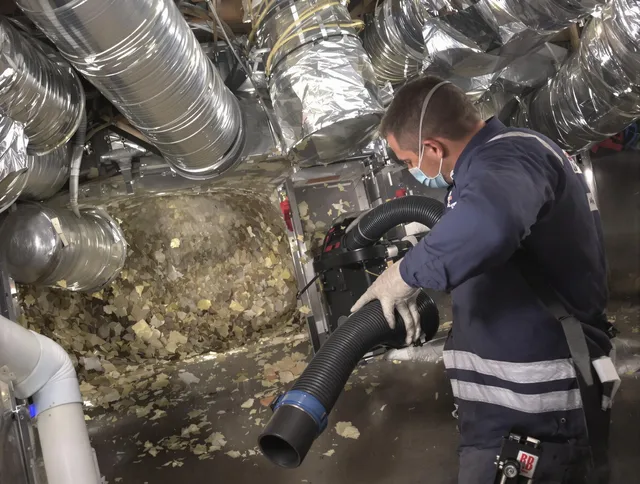 Medfield Air Duct Cleaning specialist operating negative pressure cleaning equipment for thorough duct maintenance in Medfield
