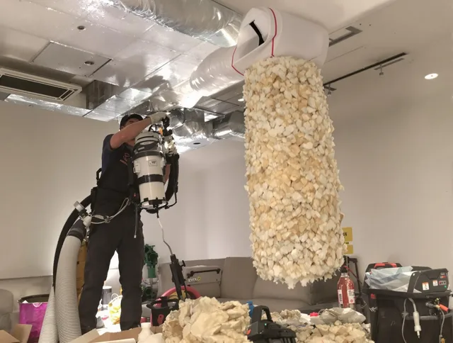 Medfield Air Duct Cleaning technician performing precision vacuum insulation removal in a residential property in Medfield