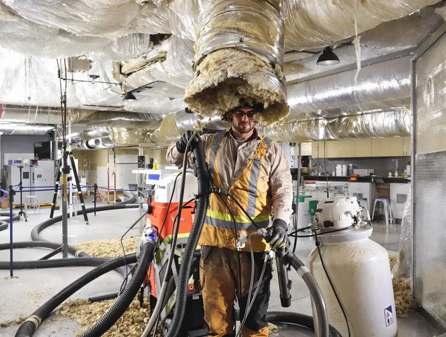 Professional vacuum insulation removal by Medfield Air Duct Cleaning expert in Medfield